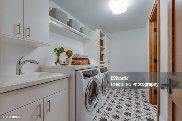 Patterned Tile Flooring In Big Laundry Room Stock Photo - Download Image Now - Utility Room, Washing Machine, Dryer
