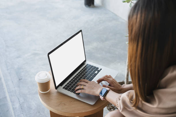 istock Side view young woman siting in coffee shop and surfing internet with laptop computer. 1320899430
