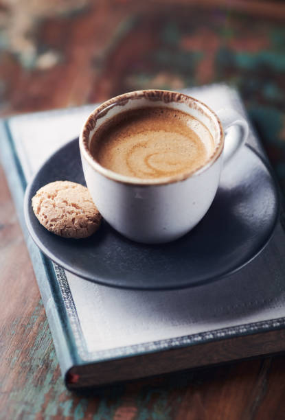 istock Cup of coffee with amaretti (Italian biscuits) on rustic wooden background. 1320899570