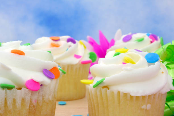 istock Birthday Cupcakes With Colorful Sprinkles on Blue 1320900763