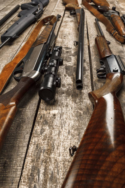 istock Many hunting rifles on weathered wooden surface 1320901392