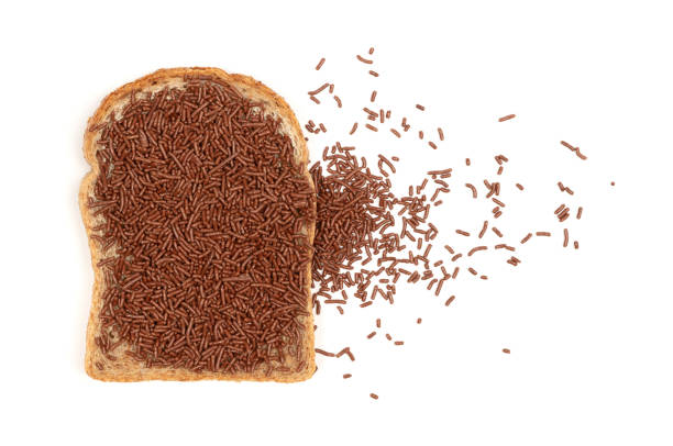 istock Typical dutch chocolate sprinkles (hagelslag) on a slice of bread, isolated 1320902733