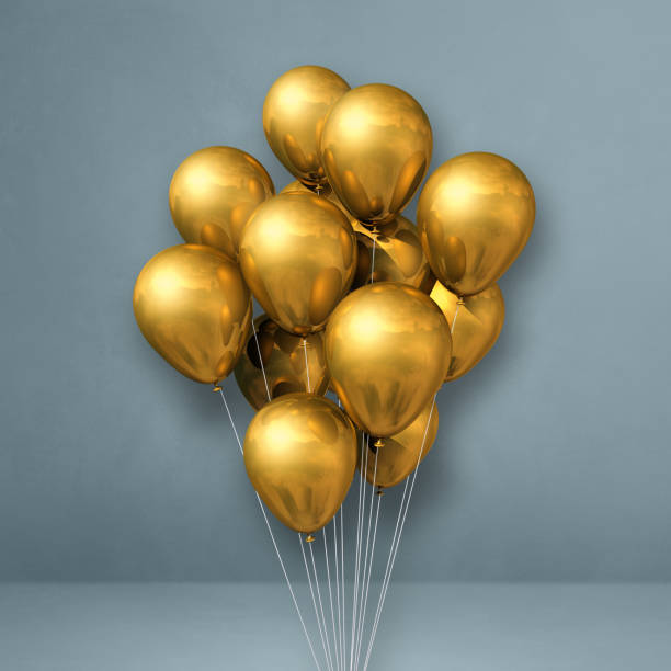 istock Gold balloons bunch on a grey wall background 1320906835