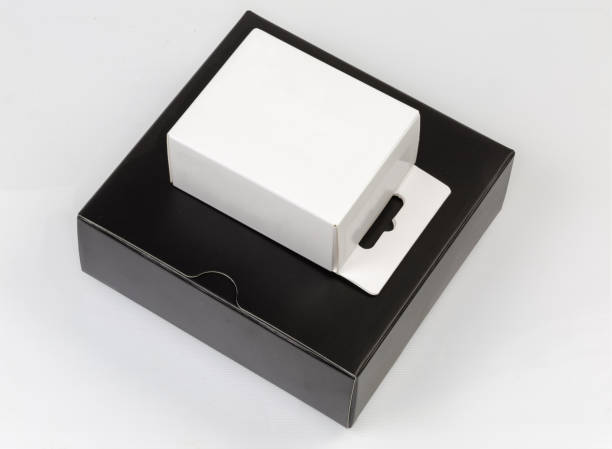 istock Closed white cardboard hang tab box on black packing box 1320907500