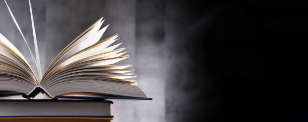 istock A composition with an open book lying on a stack of other books 1320908029