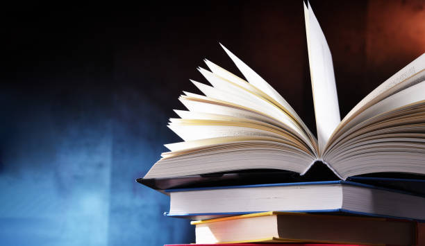 istock A composition with an open book lying on a stack of other books 1320908039
