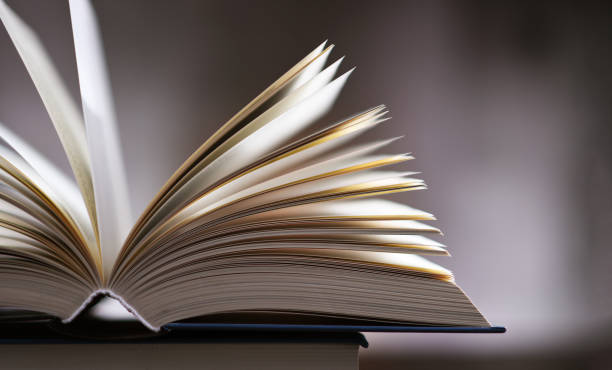 istock A composition with an open book lying on a stack of other books 1320908060