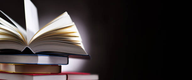 istock A composition with an open book lying on a stack of other books 1320908094