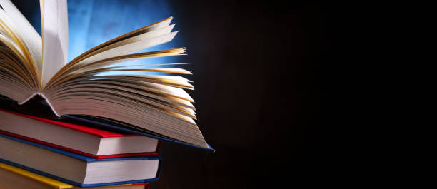 istock A composition with an open book lying on a stack of other books 1320908114
