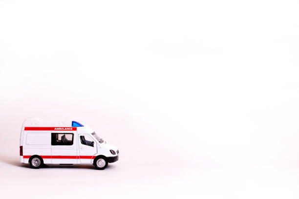 African male paramedic driving ambulance in residential area