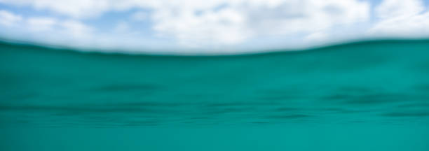 istock Blue water below the waves and a cloudy sky above the surface 1320909473