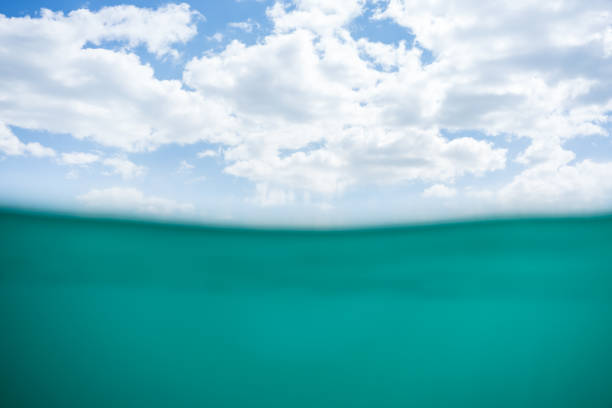 istock Blue water below the waves and a cloudy sky above the surface 1320909480