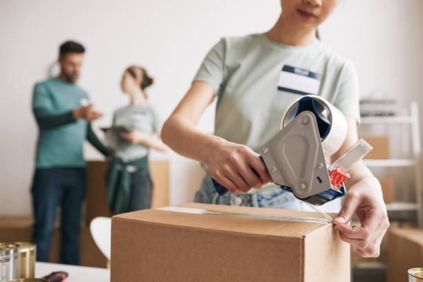 istock Woman Packing Boxes at Charity Event 1320910657