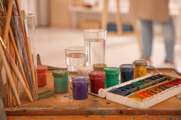 istock Paints and brushes in artist studio, closeup 1320910706