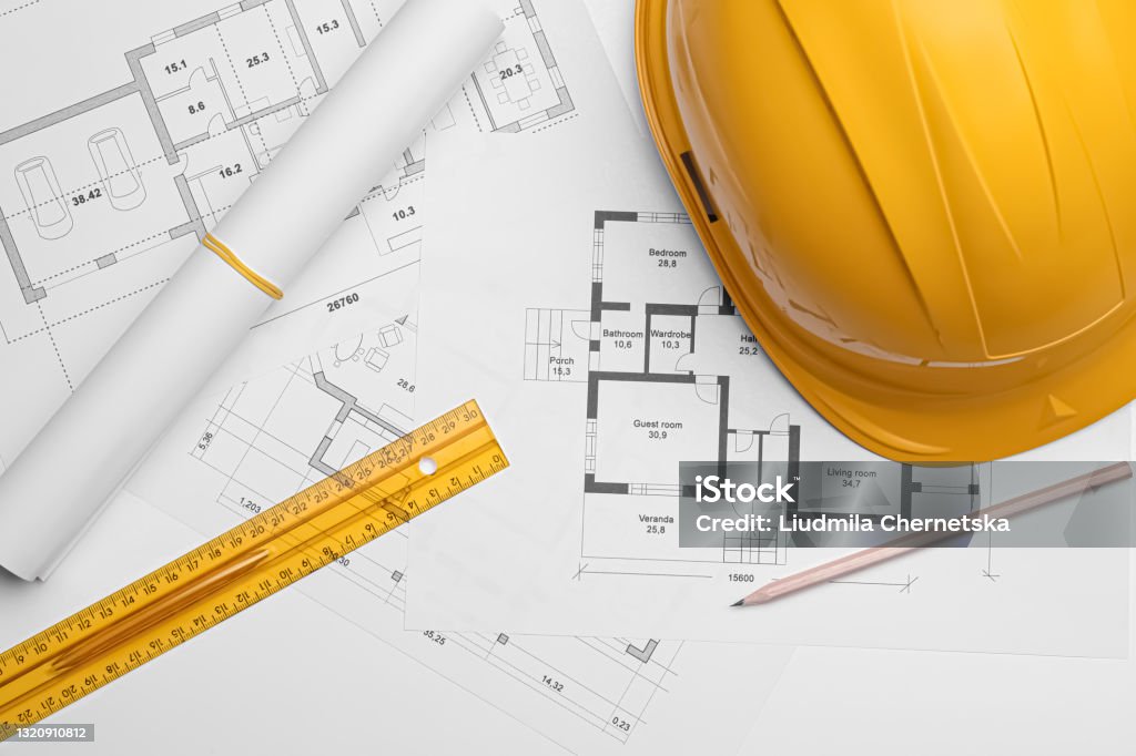 Flat lay composition with blueprints and hardhat on white background Blueprint Stock Photo