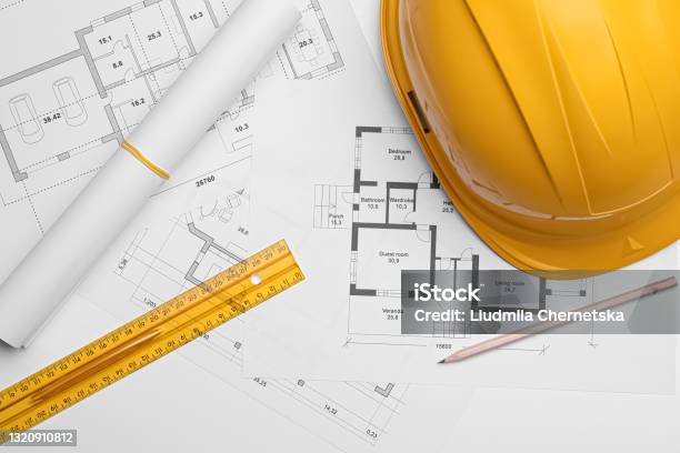 Flat Lay Composition With Blueprints And Hardhat On White Background Stock Photo - Download Image Now