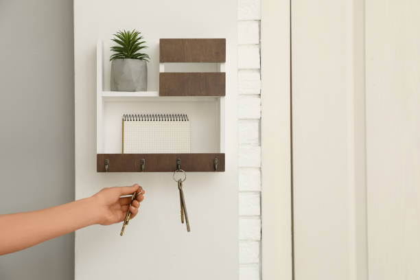 istock Woman taking keys from hanger in hallway, closeup 1320910911