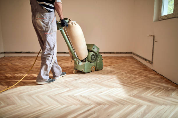 istock Repairman restoring parquet with a sanding machine. 1320912134
