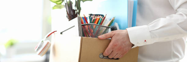 istock Fired man carrying box with personal belongings 1320914047