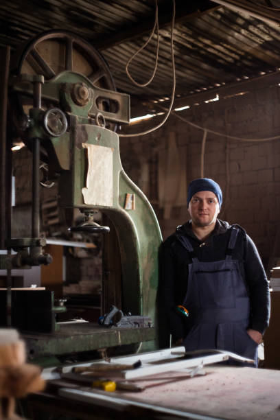 istock Young adult carpenter in his work shop 1320914078