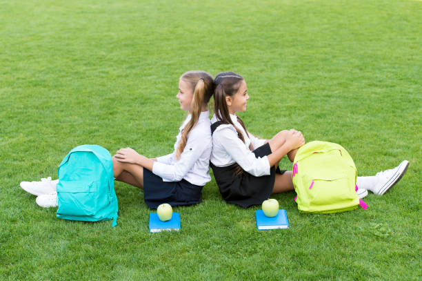 istock School friends relaxing after classes at school yard, hard day concept 1320914091
