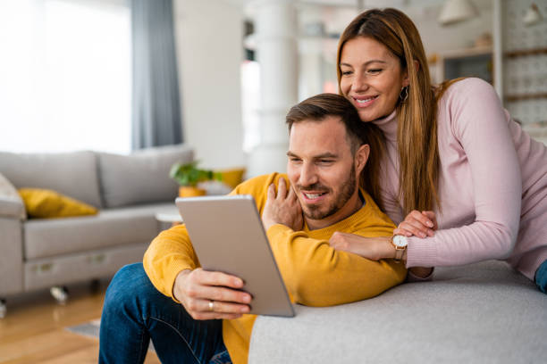 istock Couple in love hugging and using tablet together. 1320914991