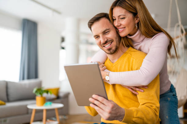 istock Happy couple spending time with tablet at home 1320915557