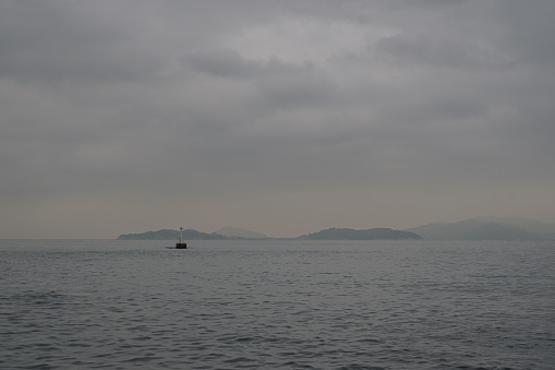 The lighthouse is seen in the distance from Lamma ferry pier. The island despite being very close to Hong Kong, offers lots of walks and other activities and is a very popular getaway for weekend tourists from Hong Kong.