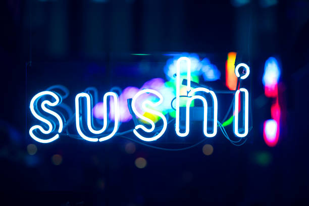 istock SUSHI glowing neon sign in showcase during night time 1320917110