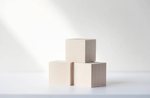 istock Three wooden square blocks or cubes on white desk. Mockup, space for text. Concept business picture 1320917114
