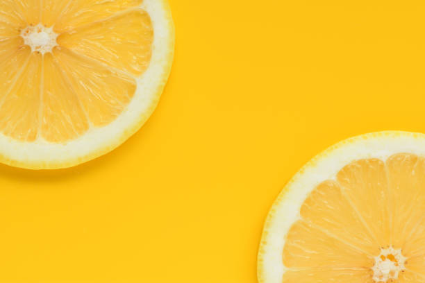 istock Fresh lemon slices on yellow background 1320917206