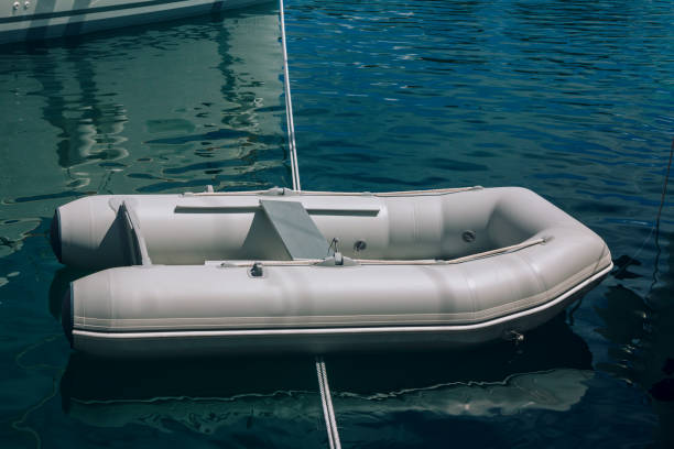 istock White lifeboat on a calm sea bay surface 1320917574