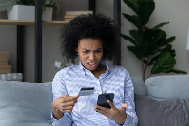 istock Unhappy biracial woman have problems paying on cell online 1320918159
