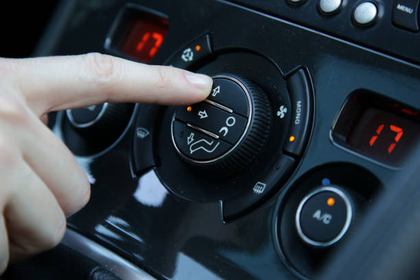 istock Hand ajusting the air conditioner in the car 1320918324