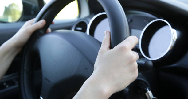 istock Woman hands on steering wheel, close up 1320918335