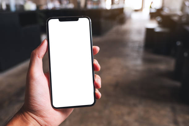 istock a man holding black mobile phone with blank white screen in cafe 1320918497