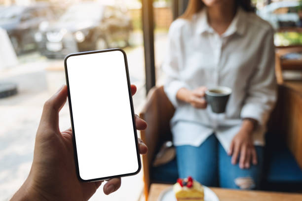 istock a man holding mobile phone with blank white screen with a woman in background 1320918506