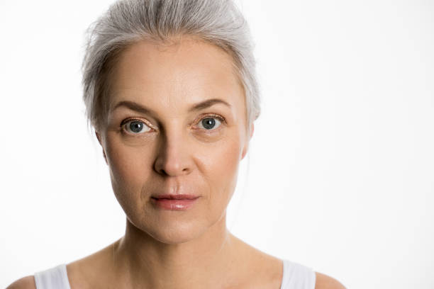 istock Senior charming caucasian lady standing opposite and looking at camera 1320918763