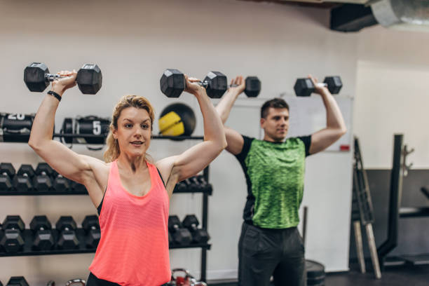 istock Man and woman exercising in gym 1320919862