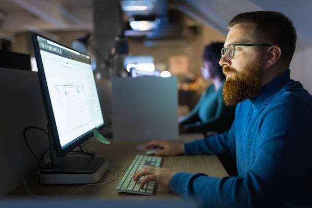 istock Group of architects  working late  in co-working space 1320919927