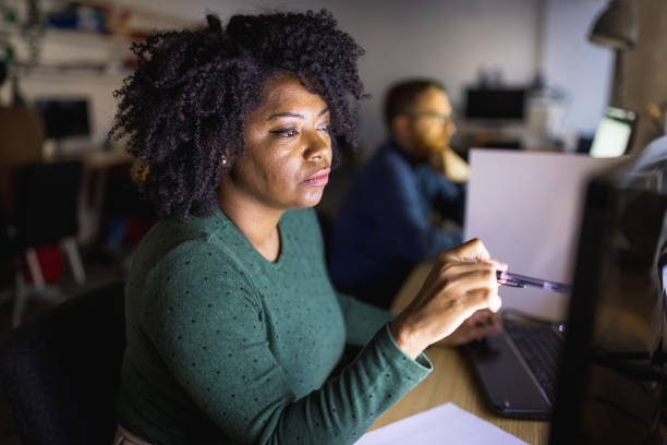 istock Group of architects  working late  in co-working space 1320919932