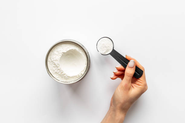 istock Hands holding protein powder in scoop. Sport nutrition 1320921085