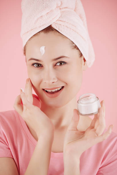 istock Woman applying brightening day cream 1320922830