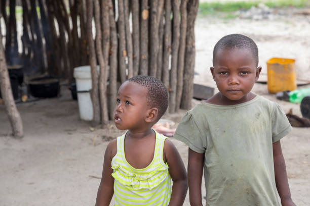 istock Small African toddler siblings standing in their yard 1320923137