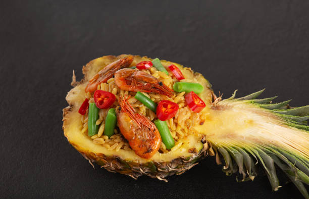 istock Stuffed pineapple thai cuisine on black background 1320924079