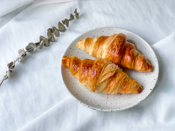 istock Freshly baked plain butter croissant. (isolated) 1320924310