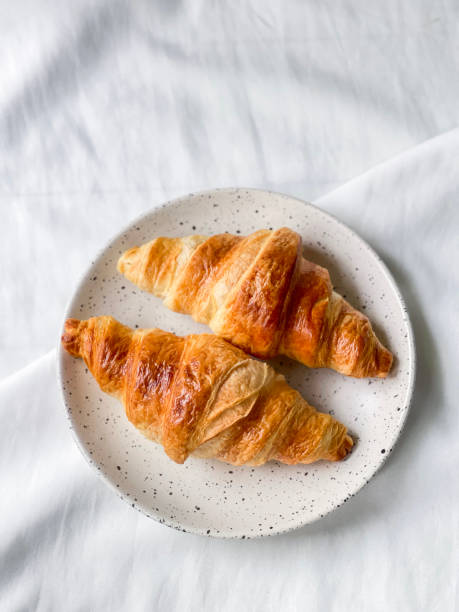 istock Freshly baked plain butter croissant. (isolated) 1320924312