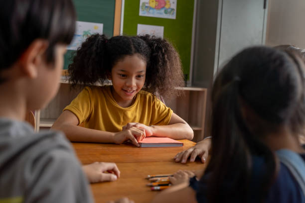 istock School girl with hands on table concentrating during challenge 1320924409