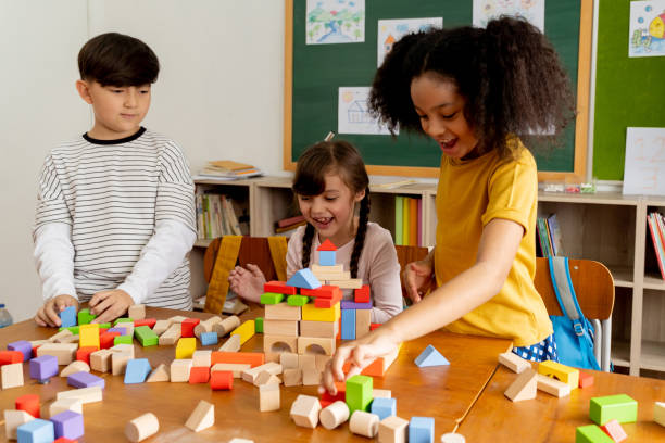 istock Children playing with wooden blocks in classroom 1320924420