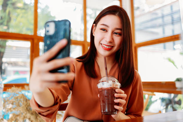 donna che si fa selfie con un drink al bar - blueberry smoothie milk shake drink foto e immagini stock